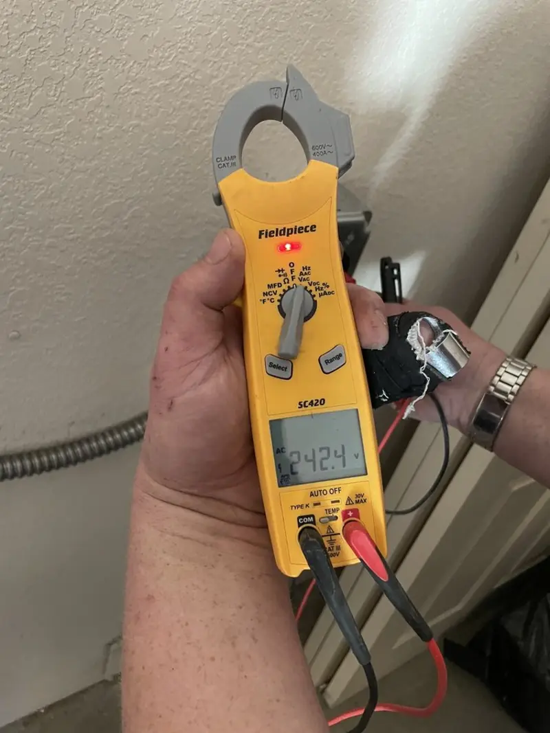Voltage testing with clamp meter during Recessed Lighting Installation in Mountain Home AFB